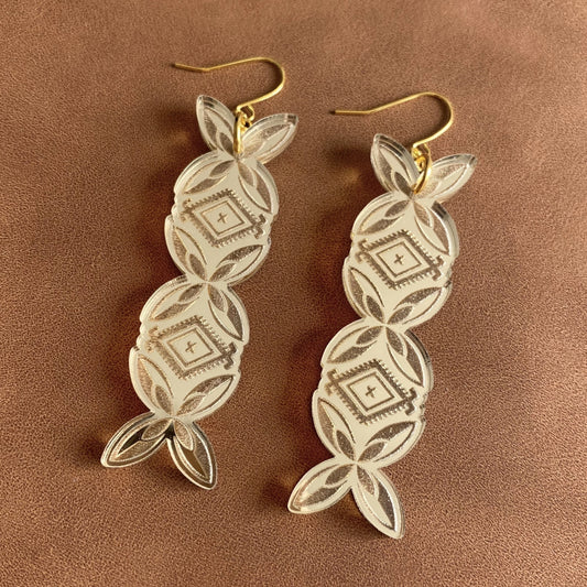 A pair of gold perspex bar earrings featuring Polynesian frangipani and malu motifs