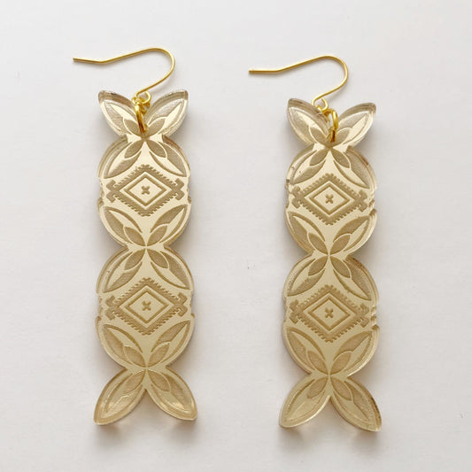 A pair of gold perspex bar earrings featuring Polynesian frangipani and malu motifs